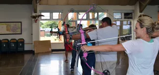 Educators shooting bowfishing equipment at an Explore Bowfishing training.