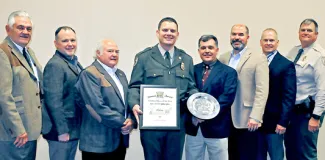 Gathered for the 2017 Officer of the Year award presentation are, from left, Wildlife Commissioner Bill Brewster, Raegen Seigfried and Robin Siegfried (all from Shikar-Safari Club International), Game Warden Spencer Grace, Law Chief Bill Hale, ODWC Director J.D. Strong, Law Assistant Chief Nathan Erdman, and Law District 8 Lt. Doug Gottschalk. (Don P. Brown/ODWC)