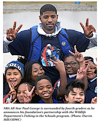 NBA all star Paul George is surrounded by 4th graders as he announces his foundation's partnership with the Wildlife Department's Fishing in the Schools program (DARRIN HILL/ODWC)