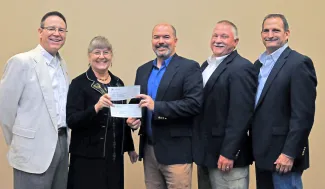 James Dietsch and Laura McIver, both of Quail Forever, present donations totalling $3,637 to ODWC Director J.D. Strong, Wildlife Chief Alan Peoples and Wildlife Assistant Chief Bill Dinkines. (Don P. Brown/ODWC)