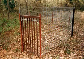 Hog trap in field.
