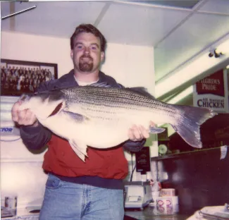 Paul Hollister holding state record Hybrid Striped Bass.