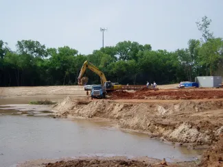 Pond Construction - Pond being built with heavy equipment.
