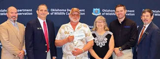Gathered for a $10,000 donation from Pheasants Forever/Quail Forever Indian Territory Chapter are, from left, ODWC Director J.D. Strong, Wildlife Chief Bill Dinkines, chapter Vice President Doug Austin, PF/QF Oklahoma Rep. Laura McIver, ODWC Upland Game Biologist Tell Judkins, and Wildlife Assistant Chief Russ Horton. (Don P. Brown/ODWC)