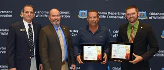 Gathered for presentation of the 2021 Firebird Award from the National Bobwhite Conservation Initiative are, from left, Wildlife Chief Bill Dinkines, ODWC Director J.D. Strong, John Weir of the Oklahoma Prescribed Burn Association (honoree), and Upland Game Biologist Tell Judkins. (Don P. Brown/ODWC)