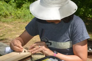 Katrina Menard works to mount a roadside-skipper she collected in southeastern Oklahoma.