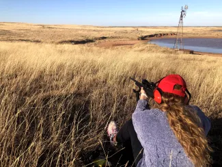 Kate Myers sights in a rifle.