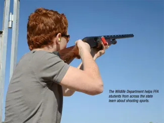 Kid shooting shotgun.