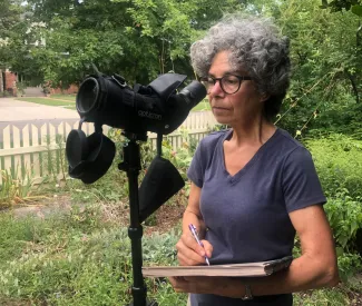 Woman looking through scope.