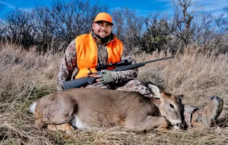 Man with harvested doe.