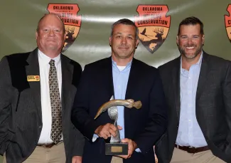 Gathered for the 2021 Fisheries Professional of the Year presentation are Chief of Fisheries Ken Cunningham, honoree Chas Patterson, and Assistant Chief of Fisheries Richard Snow.