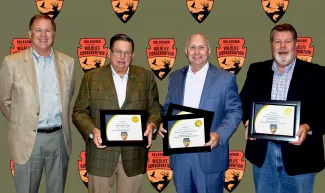 Recognizing individual $5,000 donations to the Oklahoma Wildlife Conservation Foundation are, from left, Rick Grundman, OWCF Director; donor John D. Groendyke; donor Scott Northcutt of Grand National Quail Club and Foundation; and donor Greg Hart of Grand National Quail Hunt Past Shooters.