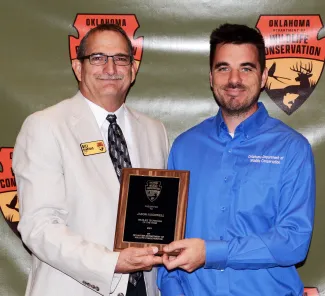 Presenting the 2021 Wildlife Technician of the Year Award are, from left, Wildlife Chief Bill Dinkines and winner OLAP Technician Jason Rockwell.