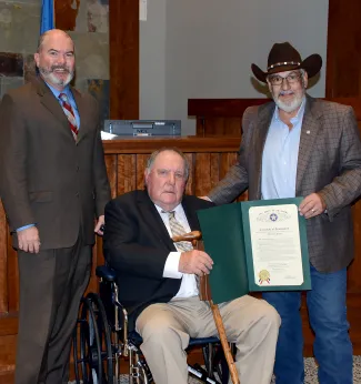 Honoring the 2022 Landowner of the Year are, from left, ODWC Director J.D. Strong, honoree Herman Jones, and state Rep. David Hardin.