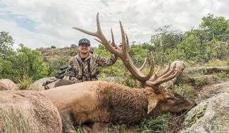 Brand Adams is seen smiling with his harvested elk.