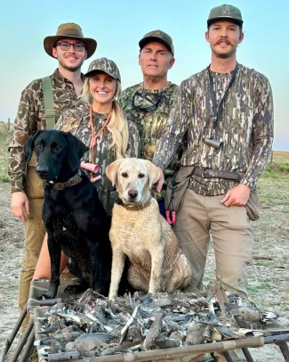 family with two dogs and doves