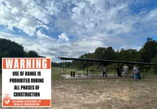 A sign reads "WARNING use of range is prohibited during all phases of construction. Oklahoma Department of Wildlife Conservation" in front of the old Canton WMA Shooting Range.