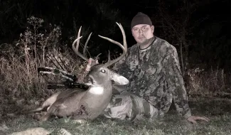 Sam Pharr is photographed with his harvest whitetail buck.