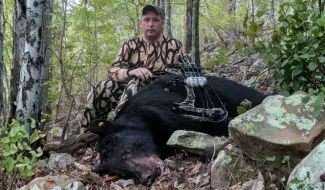 Sam Pharr is photographed with his harvested bear.