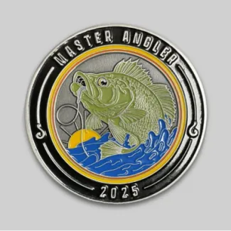 A photo of one side of the Master Angler challenge coin that shows a hooked fish jumping out of the water.