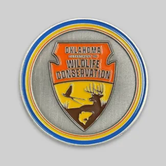 One side of the Master Angler challenge coin that shows the Oklahoma Department of Wildlife Conservation's logo.