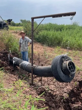 ohn Sanders works with some of the water control structures that he designed and built for his property.