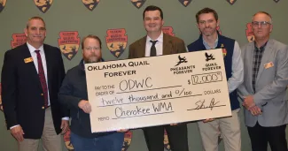 People are gathered around a large check