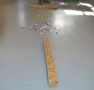 The foraging activity has two four-by-four posts with pipe cleaners sticking out, small animal figures in a pile on the floor.