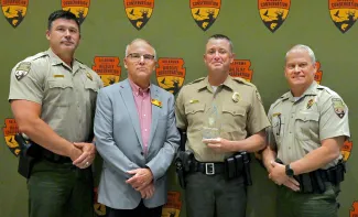 From left, Lt. Col. Wade Farrar, Assistant Chief of Law Enforcement; ODWC Director Wade Free; deMontigny; and Law Enforcement Chief Col. Nathan Erdman.