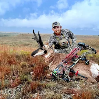 A hunter poses with his harvested pronghorn.