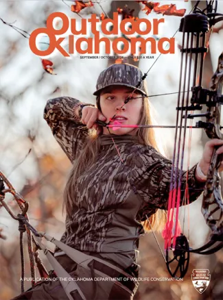 woman in camo pulling back bowstring