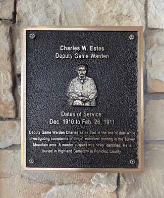 A plaque honoring Charles Estes Plaque.