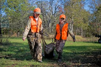 Two hunters with their harvest