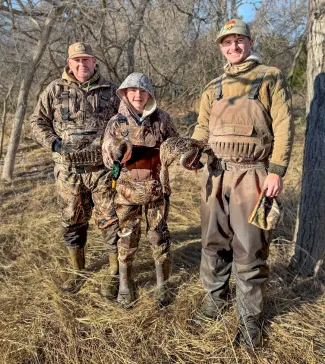 two men and a boy duck hunting