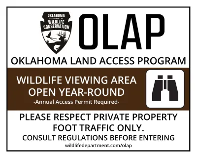 A born, black and white OLAP sign that reads, "Wildlife viewing area open year-round. Annual Access Permit required. Please respect private property, foot traffic only. Consult regulations before entering."